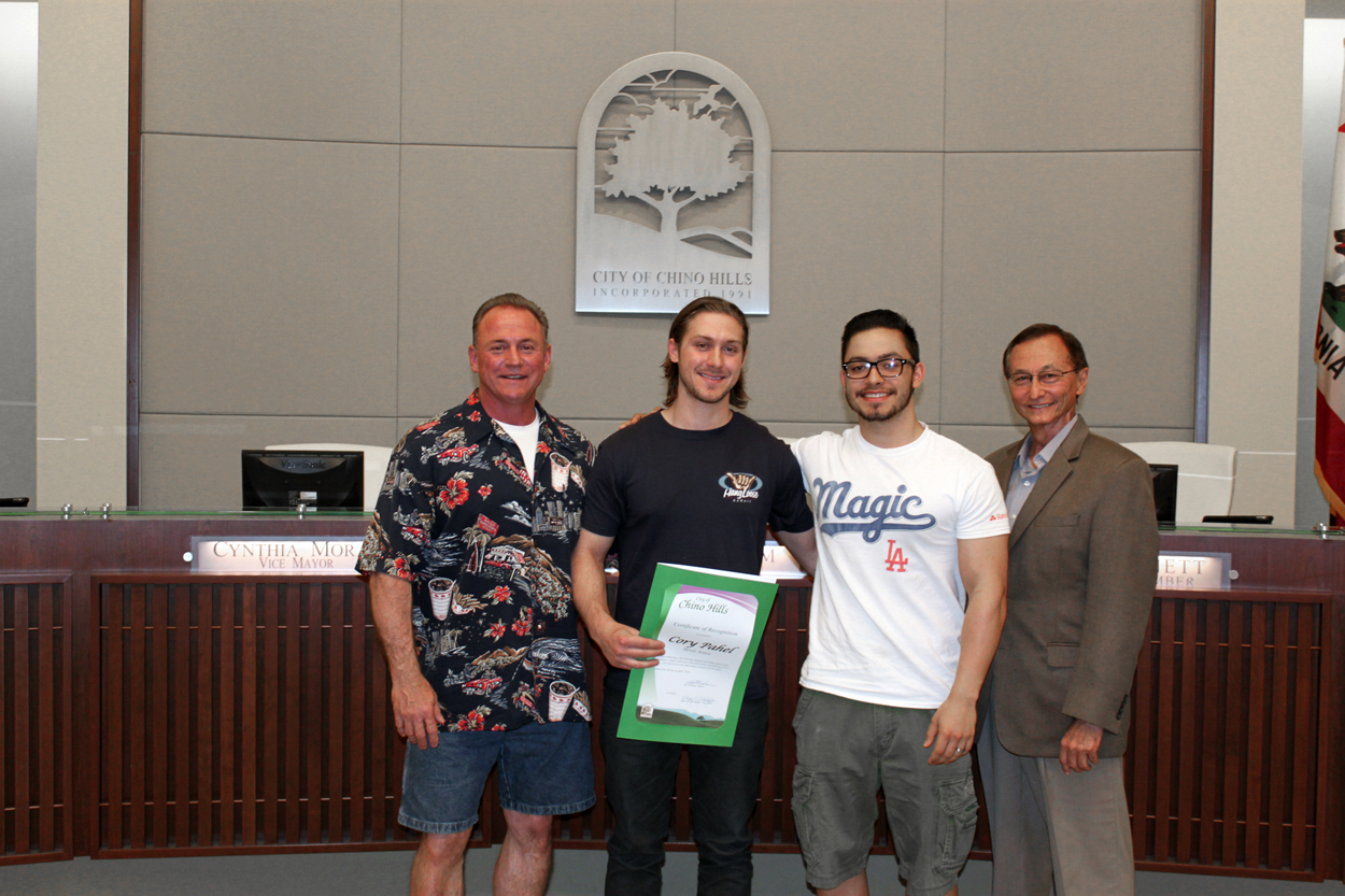 Photo of Corey Pahel, family members, and Mayor Ed Graham